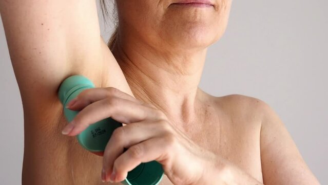 Close Up Mature Woman Applying Antiperspirant On Armpit.