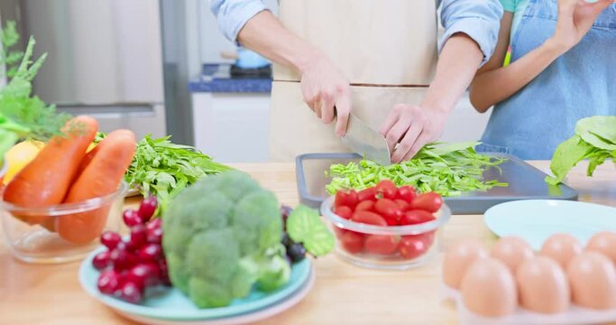 couple are cutting vegetable