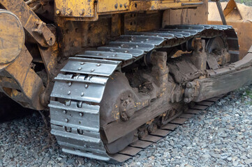 muddy rusty agricultural tractor wheels with steel tracks in mud