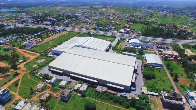 An aerial view of a warehouse located in rural Tamil Nadu near a state highway.