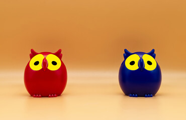 Red and blue plastic Owl toys isolated on orange background.