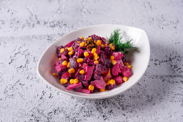 Vinaigrette, red beet salad, corn. on a light concrete background