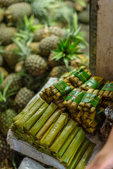 Suman or budbud, a rice cake wrapped in banana leaves, for sale in a public market in Tagaytay. A...