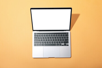 Fototapeta na wymiar Laptop with blank screen on beige background