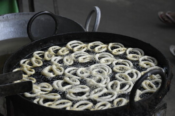 Making of Indian popular sweet dish Jalebi. Jalebi, also known as jilapi, jilebi, jilipi, zulbia, jerry, mushabak, or zalabia, is a popular Indian sweet snack.