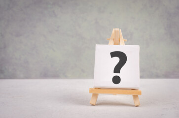 Question mark on an easel, education and business concept, searching for answers, thoughts for...