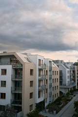 Obraz premium Modern apartment building with green zones below. Concept of an ecofriendly real estate investment in Europe
