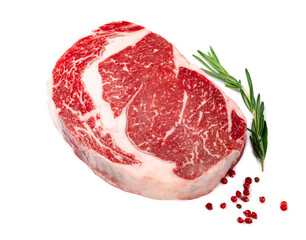 Raw rib eye steak of marbled beef with seasonings isolated on white