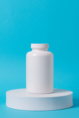 Close up picture of medication bottle of pills on the white blocks.