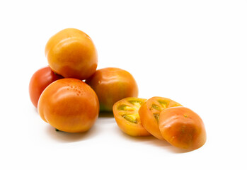Group of Tomatoes with a slices tomato close up isolated on white background.