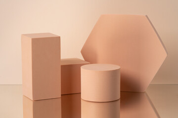 Geometric composition of aesthetic beige figures exposed on the beige background.