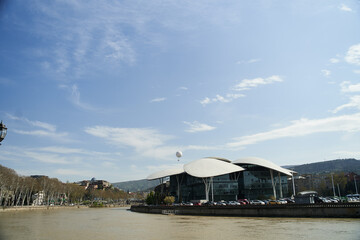 Tbilisi, Georgia - 15.04.2021: Georgia Public Service Hall building across the Kura River. Modern architecture of Tbilisi. Justice Palace in Tbilisi.