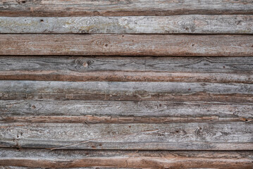 Background texture of an old wooden wall, consisting of roughly sawn and weathered wooden boards