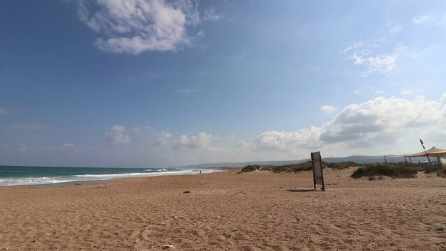 time lapse of light clouds, above the sea waves of Atlit coast in northern Israel