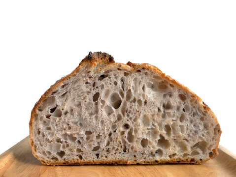 Close up Side view inside of baked brown homemade sourdough on the wooden plate, isolated, plain background with copy space and clipping path