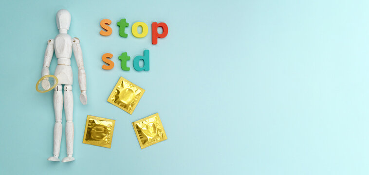 Condoms STOP STD text on blue background. Safe sex concept. Healthcare concept, world AIDS day. Copy space
