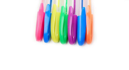 Multicolored gel pens isolated on a white background, close-up. Copy space