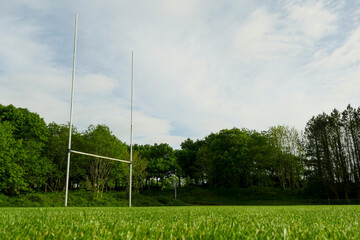 Tall goal post for rugby, hurling and camogie training. Popular active game in Ireland. National sport. Park with sport field. Low angle shot.