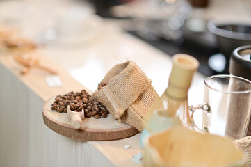 Closeup of Lots of coffee beans on the logs, with sacks of coffee beans placed inside a coffee shop cafe in Thailand.