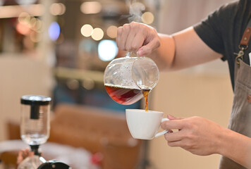 Closeup of Professional Barista making coffee prepare coffee according to orders from customers in the coffee shop at Thailand. Selective Focus.