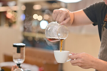 Closeup of Professional Barista making coffee prepare coffee according to orders from customers in the coffee shop at Thailand. Selective Focus.