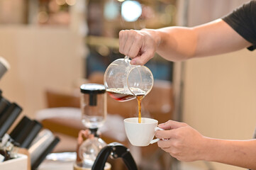 Closeup of Professional Barista making coffee prepare coffee according to orders from customers in the coffee shop at Thailand. Selective Focus.
