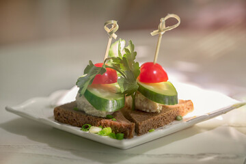 Toasts with black bread, cucumber and tomatoes