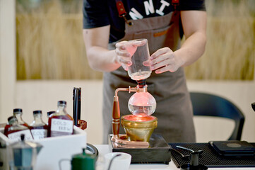 Closeup of Professional Barista making coffee prepare coffee according to orders from customers in the coffee shop at Thailand. Selective Focus.