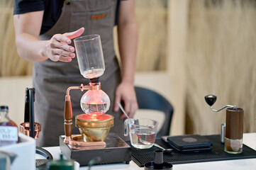 Closeup of Professional Barista making coffee prepare coffee according to orders from customers in the coffee shop at Thailand. Selective Focus.