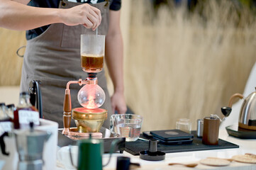 Closeup of Professional Barista making coffee prepare coffee according to orders from customers in the coffee shop at Thailand. Selective Focus.