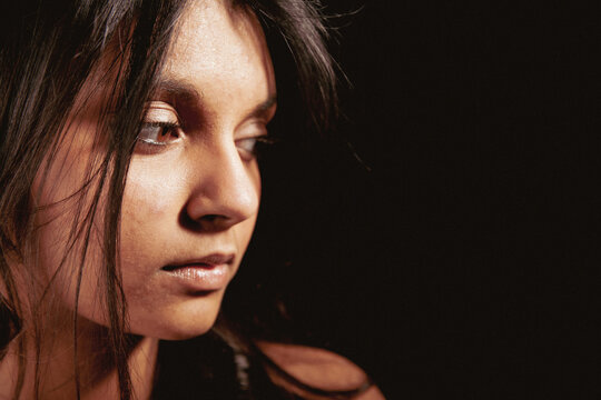 Brown Eyed Regret. A nervous glance away from a beautiful young mixed race Anglo-Indian female model. From a series of images with the same model.