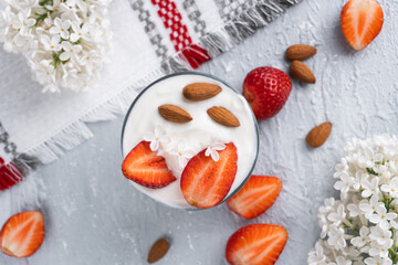Ricotta dessert with fresh strawberries. Healthy breakfast of yogurt, strawberry and almonds