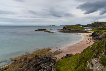Scottish Highlands coastline and the beauitful golden pink sand beach of Clashnessie in Sutherland