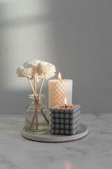Home aroma fragrance diffuser and burning candles on marble background. Interior elements. - 515327518
