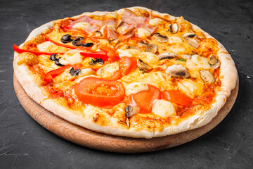 hot delicious traditional italian pizza on a dark stone background
