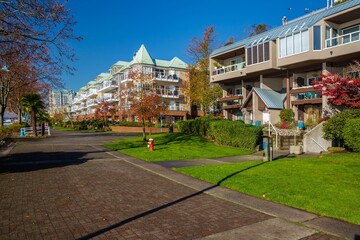 Fototapeta premium Promenade path along the Fraser River in New Westminster City. Apartment Buildings at the waterfront of New Westminster Downtown