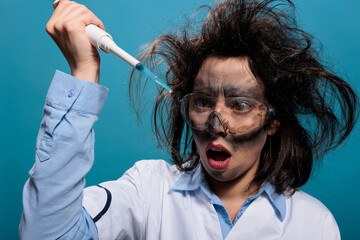 Lunatic chemist looking shocked at professional pipette filled with experimental liquid substance....