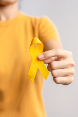 Suicide prevention day, Childhood, Sarcoma, bone and bladder cancer Awareness month, Yellow Ribbon for supporting people life and illness. Healthcare and World cancer day concept - obrazy, fototapety, plakaty