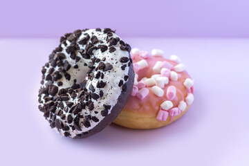 Stack of tasty sweet donuts with sprinkles on table