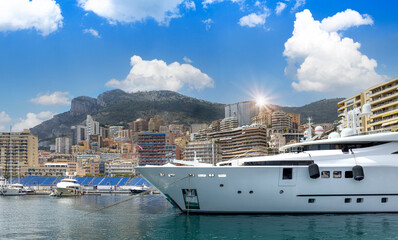 France, French Riviera, Monte Carlo marina with luxury yachts and cars in Monaco bay.