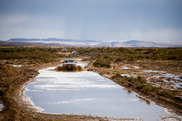 Car on flooded fields of Bolivia. Landscapes of the La Paz - Uyuni Road