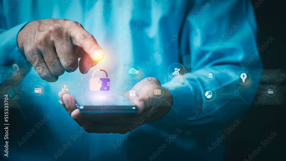 Wall mural young businessman is using a mobile phone to access security system
