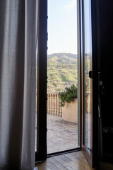 Open door and terrace with mountain view. High quality photo