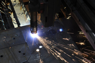 Plasma cutting of metal with CNC, modern industrial technologies. Warning - accurate shooting in difficult conditions.