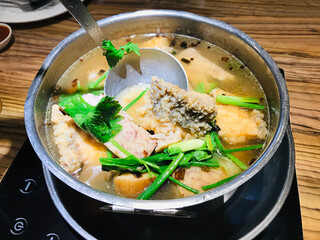 Fried Bonito Sea Bass and Taro in Clear Soup on Hot Pot in Thailand.