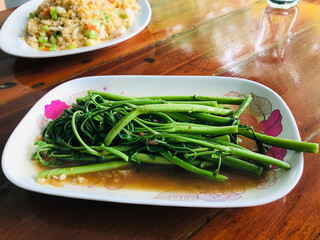Stir fried mimosa with oyster sauce in Thailand.