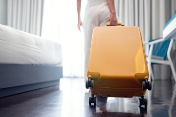 Closeup - Tourist woman with luggage in hotel after check-in. Conceptual of travel and vacation.