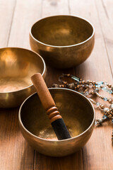Tibetan singing bowls on a wooden table.