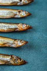 A pattern of smoked capelin on a blue background.