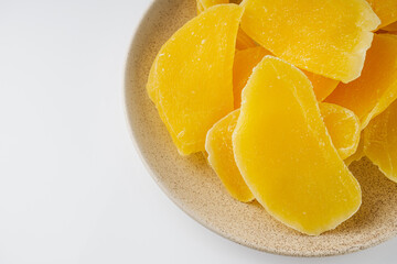 Fototapeta na wymiar delicious dried mango on a white acrylic background